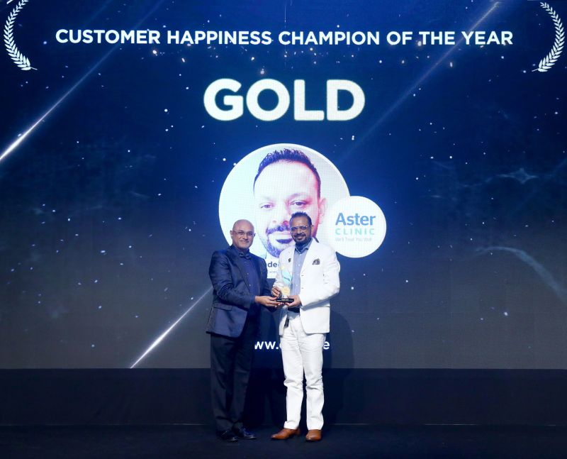 MAGICX founder Pradeep Kumar receiving a gold award on stage under a Customer Happiness Champion of the Year banner