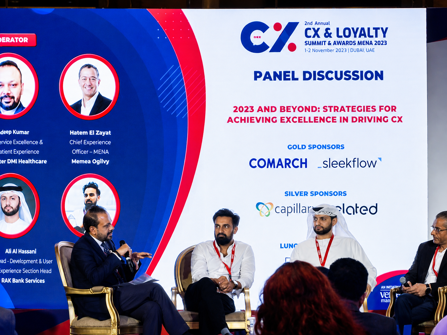 Panel speakers on stage in front of a slide titled 2023 and Beyond: Strategies for Achieving Excellence in Driving CX