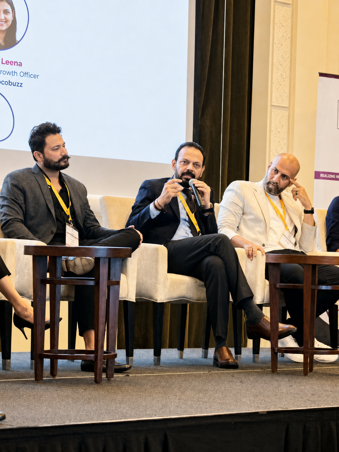 Three panellists seated on stage mid-discussion at a customer experience conference