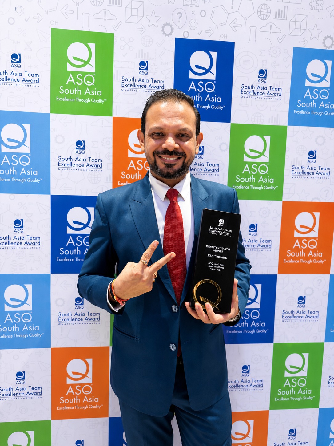 MAGICX founder Pradeep Kumar holding an ASQ South Asia Industry Sector Winner Healthcare trophy